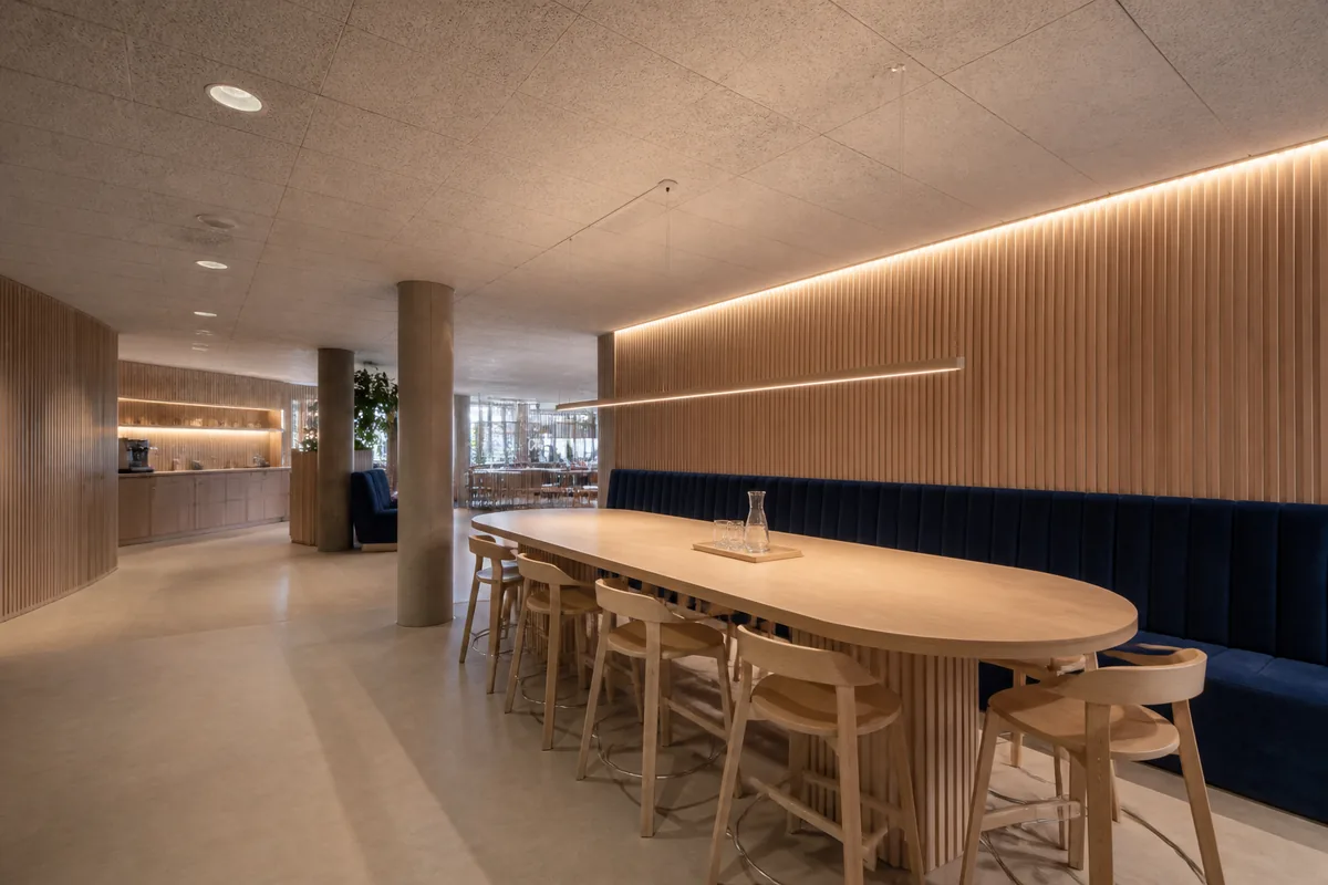 Plafond acoustique clair et banquette capitonnée dans un coin repas d&rsquo;entreprise